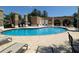 This community pool is surrounded by lounge chairs and has a bathroom and tanning area at 20903 Amanda Oak Ct, Land O Lakes, FL 34638