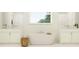 Bright bathroom with white cabinets, a soaking tub, and natural light at 22075 Storybook Cabin Way, Land O Lakes, FL 34637