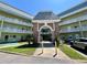 The condo complex features light-yellow paint, white railings, and well-maintained landscaping at 2459 Columbia Dr # 17, Clearwater, FL 33763