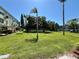 Expansive community green space with manicured lawns, mature trees, and lush landscaping at 2459 Columbia Dr # 17, Clearwater, FL 33763
