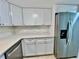Well-lit kitchen features stainless steel appliances, white cabinets, and modern countertops for a stylish cooking experience at 2459 Columbia Dr # 17, Clearwater, FL 33763