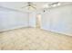Spacious living room with neutral tile flooring, a ceiling fan, and recessed lighting, offering a bright and airy feel at 2459 Columbia Dr # 17, Clearwater, FL 33763