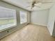 Light-filled room with tile flooring, ceiling fan, and view to the outdoors offers an inviting living area at 2459 Columbia Dr # 17, Clearwater, FL 33763