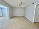 Spacious living room with ceiling fan and neutral tile flooring ready for your personal touch and decor at 2459 Columbia Dr # 17, Clearwater, FL 33763
