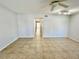 Spacious living room featuring durable tile flooring, a modern ceiling fan, and access to a hallway at 2459 Columbia Dr # 17, Clearwater, FL 33763