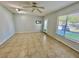 Bright living room with tile flooring, ceiling fan, and a glass-paneled door providing access to the outside at 2459 Columbia Dr # 17, Clearwater, FL 33763