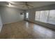 Bright living room featuring tile flooring, a ceiling fan, and large windows with light-filtering blinds at 2459 Columbia Dr # 17, Clearwater, FL 33763