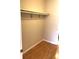 A walk-in closet with a hanging rack and wood-look flooring at 2625 State Road 590 # 1822, Clearwater, FL 33759