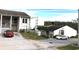 Exterior view of a white two-story condo building with well-maintained landscaping and reserved parking at 2625 State Road 590 # 1822, Clearwater, FL 33759