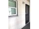 Exterior view of the front door with secure iron gate and storm door at 2625 State Road 590 # 1822, Clearwater, FL 33759