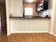 The bright kitchen area has wood-look flooring, a breakfast bar and stainless steel appliances at 2625 State Road 590 # 1822, Clearwater, FL 33759