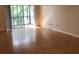 Spacious living room with wood-look flooring and sliding glass doors to the patio at 2625 State Road 590 # 1822, Clearwater, FL 33759