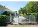 Beautiful backyard featuring a pool gate leading to a lush, landscaped yard with mature trees at 2990 Eagle Estates W Cir, Clearwater, FL 33761