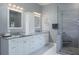 Bathroom featuring granite countertops, dual sinks, and glass enclosed shower with built-in bench at 2990 Eagle Estates W Cir, Clearwater, FL 33761