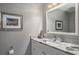 Elegant bathroom featuring granite countertops, a modern sink, and stylish decor at 2990 Eagle Estates W Cir, Clearwater, FL 33761