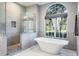 Luxurious bathroom featuring a soaking tub, walk-in shower, and stylish finishes at 2990 Eagle Estates W Cir, Clearwater, FL 33761