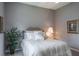 Serene bedroom featuring a plant, comfortable queen bed, and side table at 2990 Eagle Estates W Cir, Clearwater, FL 33761