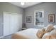Bedroom featuring a comfortable bed, closet, and a side chair at 2990 Eagle Estates W Cir, Clearwater, FL 33761