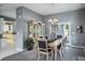Bright dining room with stylish chandelier and views of the kitchen at 2990 Eagle Estates W Cir, Clearwater, FL 33761