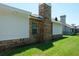 Exterior view of the home showcasing the brick detailing, chimney, and well-maintained lawn at 2990 Eagle Estates W Cir, Clearwater, FL 33761