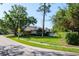 Charming single-story home with lush landscaping and a white fenced in patio at 2990 Eagle Estates W Cir, Clearwater, FL 33761