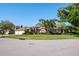 Traditional brick home with a three car garage and mature landscaping on a corner lot at 2990 Eagle Estates W Cir, Clearwater, FL 33761