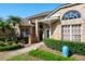 Elegant brick home with decorative windows and a charming entryway framed by manicured greenery at 2990 Eagle Estates W Cir, Clearwater, FL 33761