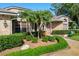 Charming home with mature landscaping, decorative brick accents, and a peaceful garden at 2990 Eagle Estates W Cir, Clearwater, FL 33761