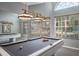 Game room with pool table and wall mirror at 2990 Eagle Estates W Cir, Clearwater, FL 33761