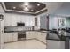 Stylish kitchen with stainless steel appliances, granite countertops, and elegant white cabinetry at 2990 Eagle Estates W Cir, Clearwater, FL 33761