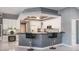 Modern kitchen with breakfast bar, granite countertops, and sleek cabinetry at 2990 Eagle Estates W Cir, Clearwater, FL 33761