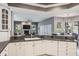 Bright kitchen with white cabinets, granite countertops, and stainless-steel appliances overlooking the living room at 2990 Eagle Estates W Cir, Clearwater, FL 33761