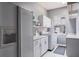 Well-equipped laundry room with modern appliances and ample cabinet space at 2990 Eagle Estates W Cir, Clearwater, FL 33761