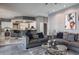 Open-concept living room featuring modern decor, comfortable sofas, and seamless access to the kitchen at 2990 Eagle Estates W Cir, Clearwater, FL 33761