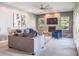 Spacious living room with a stone fireplace, comfortable seating, and ample natural light at 2990 Eagle Estates W Cir, Clearwater, FL 33761