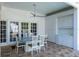 Covered patio with outdoor kitchen, dining table, and view of the backyard through glass doors at 2990 Eagle Estates W Cir, Clearwater, FL 33761