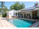 Backyard pool with attached spa and solar panels on the roof at 2990 Eagle Estates W Cir, Clearwater, FL 33761
