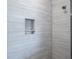 Shower featuring a tiled inset niche for soaps and shampoos at 2990 Eagle Estates W Cir, Clearwater, FL 33761