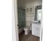 Bathroom with shower, toilet, vanity, and cabinet above toilet at 29931 Playa Del Rey Ln, Wesley Chapel, FL 33543