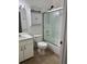 Bright bathroom featuring a shower with glass doors, white cabinets, and modern fixtures at 29931 Playa Del Rey Ln, Wesley Chapel, FL 33543