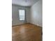 Cozy bedroom with hardwood floors, window, and natural light at 29931 Playa Del Rey Ln, Wesley Chapel, FL 33543
