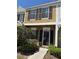 Two-story home featuring an inviting front entrance, dark shutters, and a well-maintained lawn with garden at 29931 Playa Del Rey Ln, Wesley Chapel, FL 33543