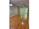 Bright living room with hardwood floors, ceiling fan, and sliding glass doors to the outside at 29931 Playa Del Rey Ln, Wesley Chapel, FL 33543