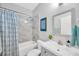 Clean bathroom with a shower-tub combo, white tile surround, and a modern vanity at 3002 E 24Th Ave, Tampa, FL 33605