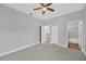 This carpeted bedroom features neutral walls, a ceiling fan, and entry doors to other rooms at 3002 E 24Th Ave, Tampa, FL 33605