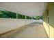 A concrete covered area enclosed by a white fence offers great utility at 3002 E 24Th Ave, Tampa, FL 33605