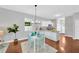 Cozy dining area with modern chandelier, hardwood floors, and kitchen view at 3002 E 24Th Ave, Tampa, FL 33605