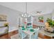 Charming dining area adjacent to the living room, featuring stylish decor and a bright window view at 3002 E 24Th Ave, Tampa, FL 33605