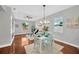 Bright dining area with modern chandelier, hardwood floors, and natural light at 3002 E 24Th Ave, Tampa, FL 33605