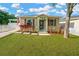 Charming home with vibrant landscaping, American flag, and a well-maintained lawn at 3002 E 24Th Ave, Tampa, FL 33605